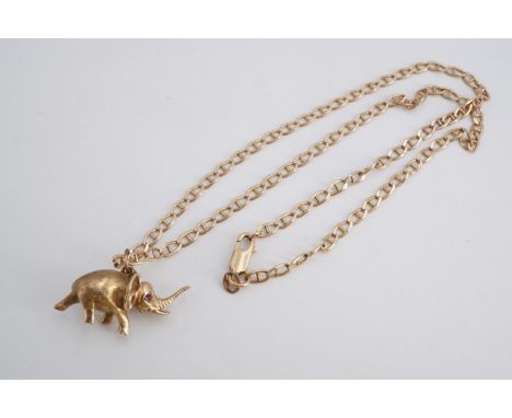 A yellow metal pendant modelled as an elephant, having ruby eyes, on a 9 ct gold marine link neck chain, 14.6 g