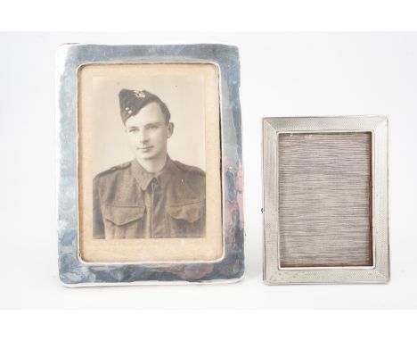 An early 20th Century silver-faced photograph frame containing a portrait of a Second World War soldier, together with a 1940