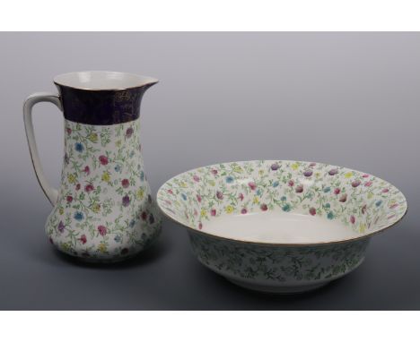 A Wedgwood wash ewer and basin, transfer-printed and hand-tinted with floral sprigs, edged with a cobalt blue and gilt band, 
