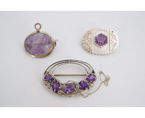 Three amethyst and white metal brooches / pendants
