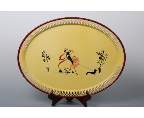 A vintage kitsch tinplate tea tray hand-enamelled in depiction of a fashionable young lady walking a dachshund, 1930s -1950s,