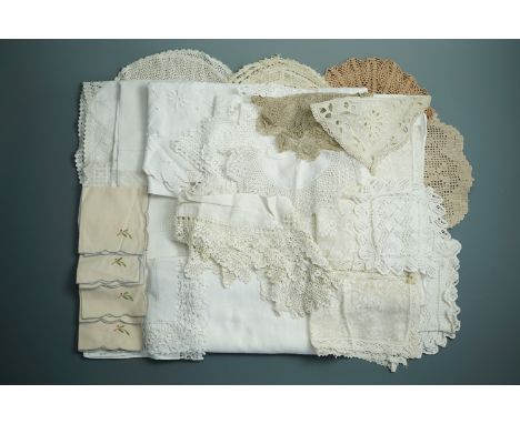 A quantity of antique and vintage whitework embroidery table linens and doilies of lace and crochet