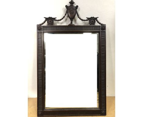 An early 20th Century Georgian-influenced mahogany-framed wall mirror, the rectangular plate in a planar frame decorated with