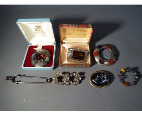 A collection of vintage, predominantly stone set brooches including three examples marked 'silver'   This lot must be paid fo