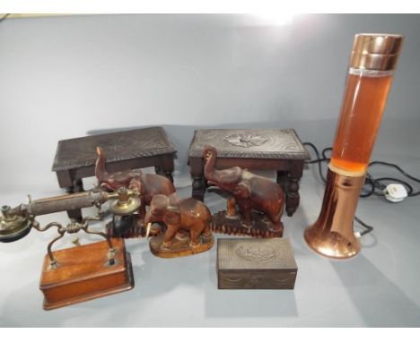 A quantity of wooden elephants, miniature tables, wooden box, vintage telephone and a lava lamp. This lot must be paid for an