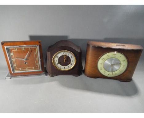 A bakelite case Smiths mantel clock, a Time Savings Clock and one other. [3]  This lot must be paid for and removed no later 