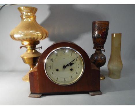 An Enfield large mantel clock with pendulum and key, also in the lot are two metal and glass oil lamps  This lot must be paid