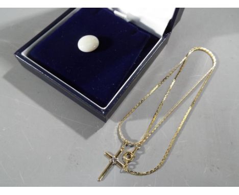 A yellow metal unmarked necklace with 9 carat gold pendant in the form of a cross, approximate weight 3.19g and a single soli