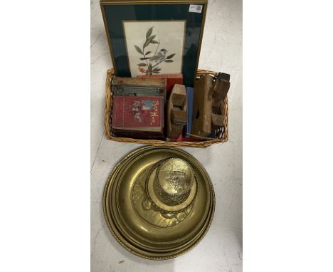 Wicker basket containing books and a print, together with three block planes and a collection of nautical themed brass plates