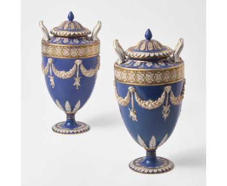 Glazed and gilt bone china.Printed Wedgwood Portland Vase mark.(H: 10 3/4, Dia: 5 1/2 in.)Qty: (2)ProvenanceCollection of Dr.