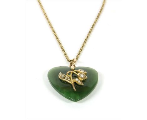 A nephrite jade and split pearl pendant, with a heart shaped cabochon nephrite jade with applied gold floral motif, grain set
