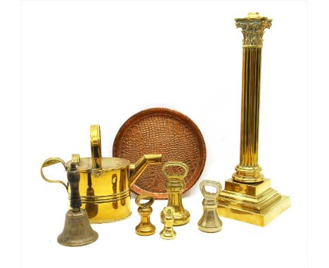 A collection of brass and copper items, to include a large Corinthian column lamp, brass bell form weights etc