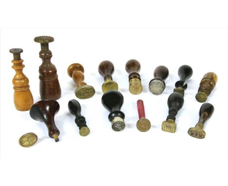 A quantity of wooden handled desk seals, the metal matrices variously intaglio engraved with initials, monograms, criss-cross
