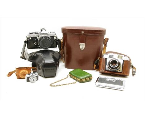 A collection of cameras, to include a Zeiss Icon camera, Mycro miniature camera, Olympus OMI camera, Carl Zeiss binoculars, a