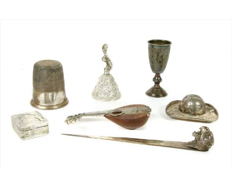 A collection of continental silver , to include a letter opener, a modelled hat, oversized German thimble, a bell, or trinket