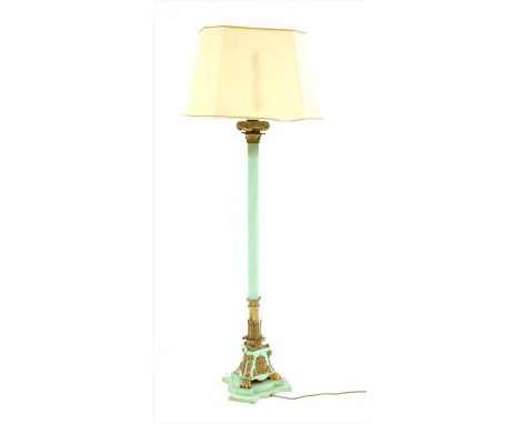 A gilt and painted metal standard lamp and shade , 20th century, on a wooden triform base, 174cm high and a modern wall mirro