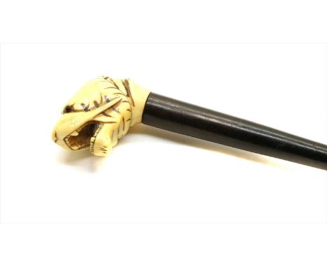 A 19th century ebony and ivory walking stick, with dog head pommel, 80cm high