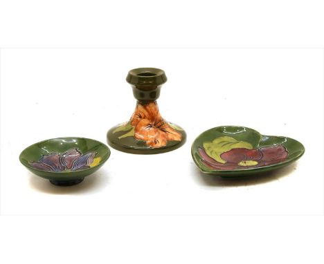 A Moorcroft Hibiscus candlestick, together with two other Moorcroft dishes, and two Hibiscus pattern table lamps (5)