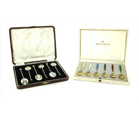 Six silver gilt and enamel Georg Jensen coffee spoons, the handles with coloured enamel panels, complete in original fitted b