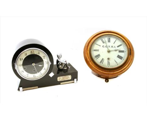 An Art Deco ebonised mantel clock, having model female adjacent on integrated plinth and silver plaque, 34cm long, together w