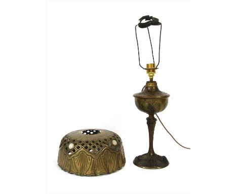 A French Art Nouveau table lamp, converted from an oil lamp, signed G Leleu, with a cast well stand and with a pierced brass 