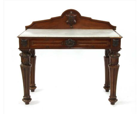 A late Victorian walnut serving table , with a raised back above an associated rectangular marble top and a carved frieze dra