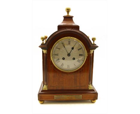An Edwardian mahogany eight day bracket clock, the silvered dial with Roman numerals, the case with arched top, spherical fin