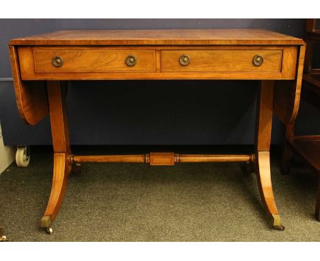 An inlaid mahogany sofa table, the crossbanded top above two frieze drawers, on outswept end supports