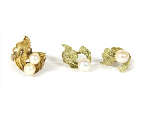 A gold cultured pearl ring and earrings suite, c.1970, the head of textured foliate form with peg set cultured pearls, to a w