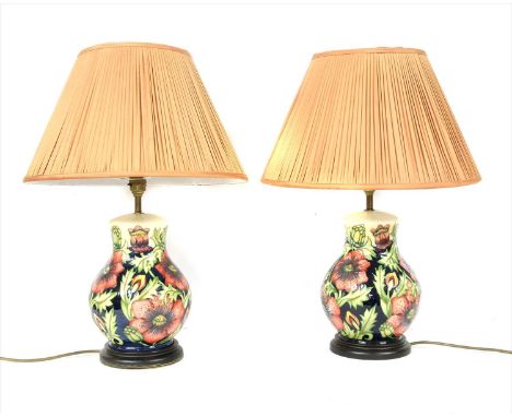 A pair of Moorcroft table lamps, in the 'Poppy' pattern, mounted on wood bases with shades, 51cm high