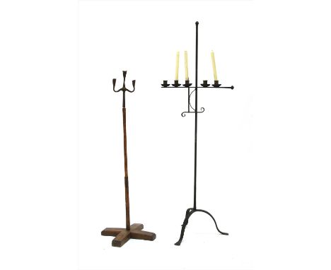 A wrought iron standing candlestick , 161cm high and another Provenance: The property of the late Mr &amp; Mrs Brian Lister, 