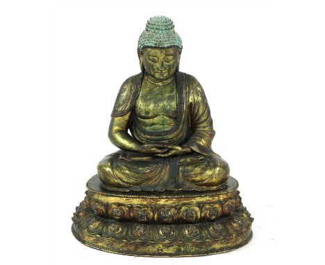 A Chinese bronze Shakyamuni Buddha, 20th century, seated cross-legged on a double lotus pedestal, his hands resting in his la