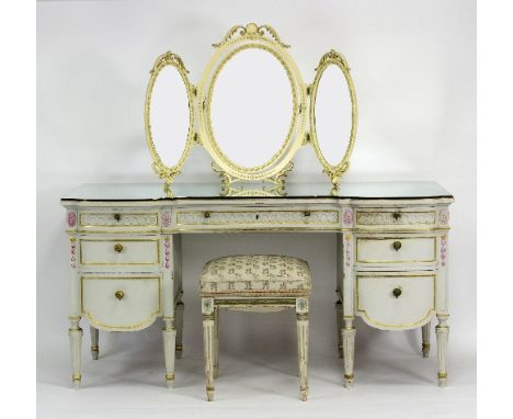 A French painted dressing table, the mirrored breakfront top above an arrangement of seven drawers around a kneehole, on flut