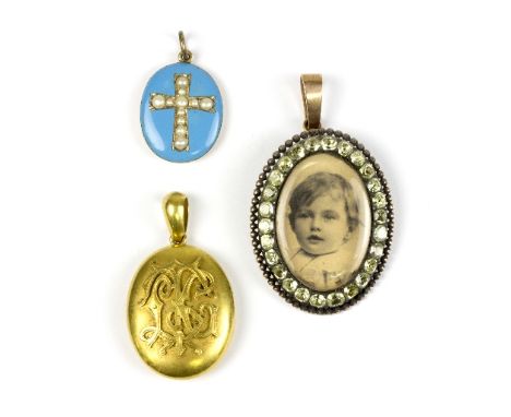 An 18ct gold oval locket, the cover with raised monogram, an oval pendant with paste set border and an enamel locket with see
