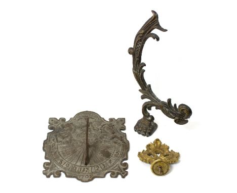 A wall mounted brass sundial, 28cm wide and two brass mounts