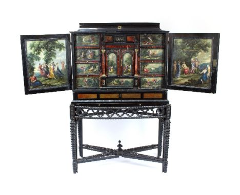 A 17th Century Flemish ebony and tortoiseshell cabinet inset with painted panels, Antwerp mid 17th Century, the hinged cover 