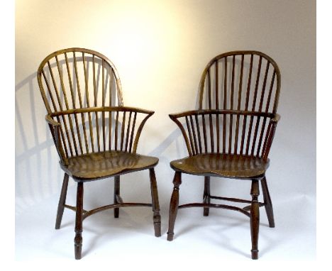 Two stick back chairs in yew with elm seats on turned legs and crinoline stretchers (both repaired)
