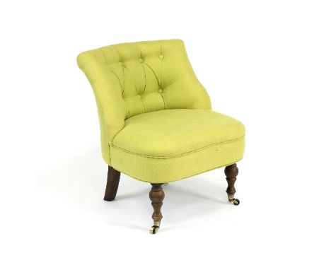 A contemporary button back bedroom chair, on turned front legs with castors, upholstered in sage green