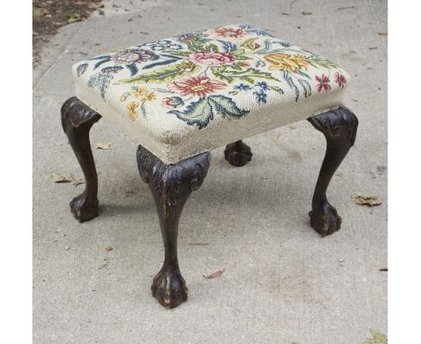 An 18th Century style stool with needlework seat on cabriole legs with claw and ball feet, 60cm wide