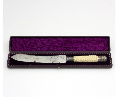 A cased bread knife with carved ivory handle