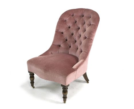 A button upholstered nursing chair, on turned front legs with castors and an open armchair with cane back and seat