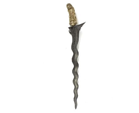 A Balinese Indonesian kris dagger with steel serpentine blade and gilded handle of batara bayu, 58cm long 