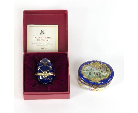 A Staffordshire enamel trinket box in the form of an egg decorated in cobalt blue highlighted in gilt and a painted porcelain