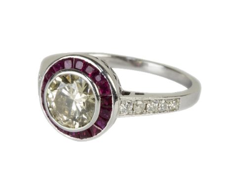 A diamond and ruby dress ring, the central brilliant cut diamond approximately 1.25ct in a rubover setting to a surround of m