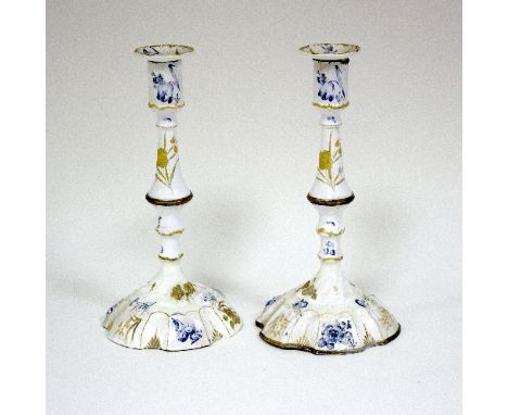 A pair of Bilston enamel candlesticks, painted flowers in blue and gilt, 25cm high