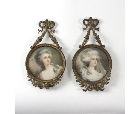 A pair of early 20th Century gilt metal miniature frames with ribbon tie surmounts, each set an engraving portrait of a lady,