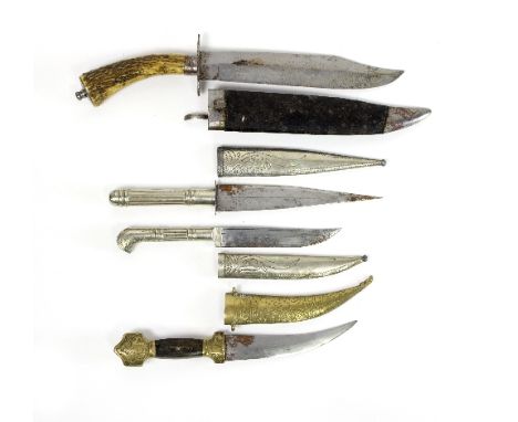 A kindjal dagger with decorative brass and wooden handle and brass sheath depicting animals together with three others