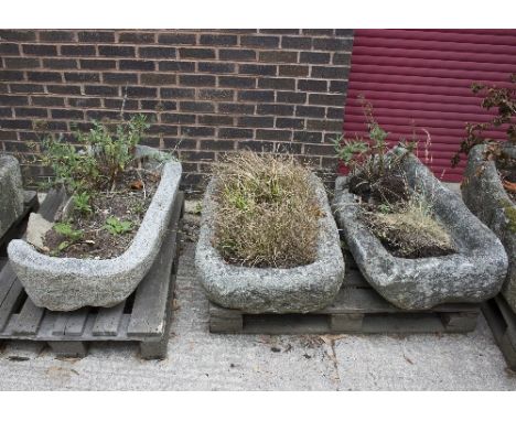 A rounded rectangular stone trough, 100cm x 82cm and two other stone troughs, both damaged