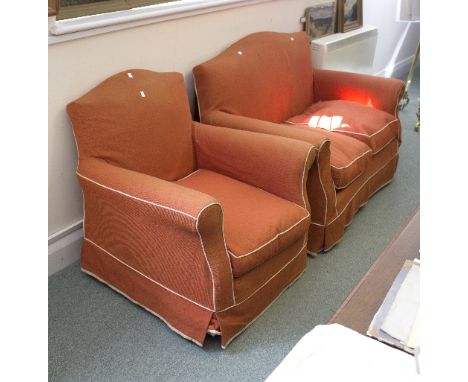 A two-seater sofa in orange loose cover and matching armchair