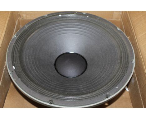 A McKenzie Acoustics 200 watt bass speaker, Model No. C15-200 boxed, 2 Peavey speakers and 3 Peavey replacement baskets, all 